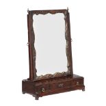 A George II mahogany dressing mirror, circa 1750, the mirror plate within a carved and parcel gilt