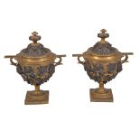 A pair of Continental parcel gilt and patinated bronze twin handled urns and covers, circa 1895, in