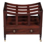 A George IV mahogany Canterbury, circa 1825, the swept top to the dividers above a frieze drawer