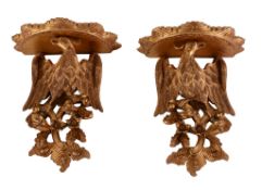 A pair of carved and giltwood wall brackets in 18th century taste, of recent manufacture, the semi-