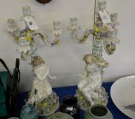 A pair of German porcelain flower-encrusted four-light figural candelabra, circa 1900, 54cm high