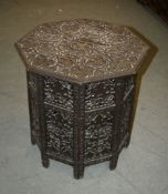 An Indian carved wood octagonal table, with pierced grapevine decoration, 64cm high, 61cm wide