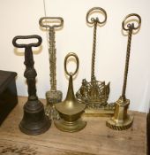 Four late Victorian brass door porters, late 19th century, and a cast iron example