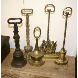 Four late Victorian brass door porters, late 19th century, and a cast iron example