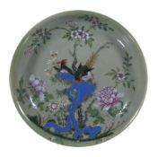 A Cantonese celadon ground Famille Rose dish, Qing Dynasty, 19th century, with a exotic bird perched