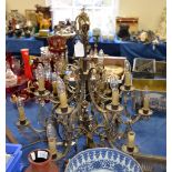 A Continental gilt metal six branch twelve light chandelier, suspending clear and amber glass drops,
