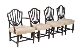 A set of four George III mixedwood dining chairs, circa 1770, to include one armchair, each with