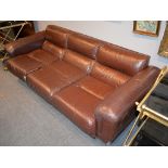 A leather upholstered three seat settee and a pair of matching armchairs, modern