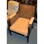 A stained beech bergÃ¨re armchair in Regency style, with caned back and sides