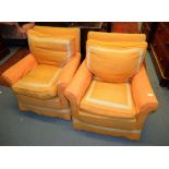 A pair of armchairs in orange upholstery and a late Victorian walnut and upholstered low armchair,