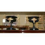 A pair of French patinated and later gold painted twin handled urns, circa 1875, with black marble