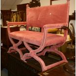 A pale red upholstered two-seat sofa in Jacobean manner, on double X-frame supports, 120cm high,