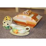 A Clarice Cliff Sungay Bizarre flower holder, a Wilkinson Honeyglaze sauce-boat and stand, and a