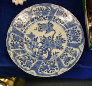 A Chinese blue and white dish, Kangxi, the centre painted with flowers issuing from pierced