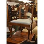 A George II mahogany chair, with a pierced vase splat and stuffed seat on foliate carved cabriole