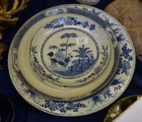 A Chinese blue and white dish, Kangxi, painted with a large pine tree, bamboo and other flowers,