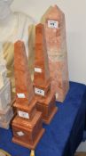 A pair of rouge marble obelisks, 20th century, on painted MDF bases, 39.5cm high overall; and a