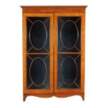 A satinwood display cabinet, circa 1800 and later, originally part of a larger cabinet, 185cm