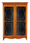 A satinwood display cabinet, circa 1800 and later, originally part of a larger cabinet, 185cm