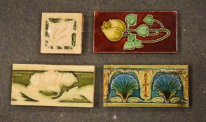 A box containing a quantity of edging tiles, various designs