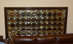 A rectangular stained wood framed wall mirror with lozenge and facetted plates, 120cm x 180cm