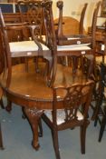 An extending mahogany dining table, on carved cabriole legs ending in claw and ball feet, 214cm long