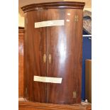 A George III mahogany hanging corner cabinet, 99cm high