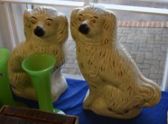 A pair of Staffordshire models of spaniels, late 19th century, sparsely coloured and gilt, 38cm high