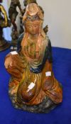 A Chinese pottery figure of Quanyin, seated in flowing robes, glazed in brown and blue, 42cm high