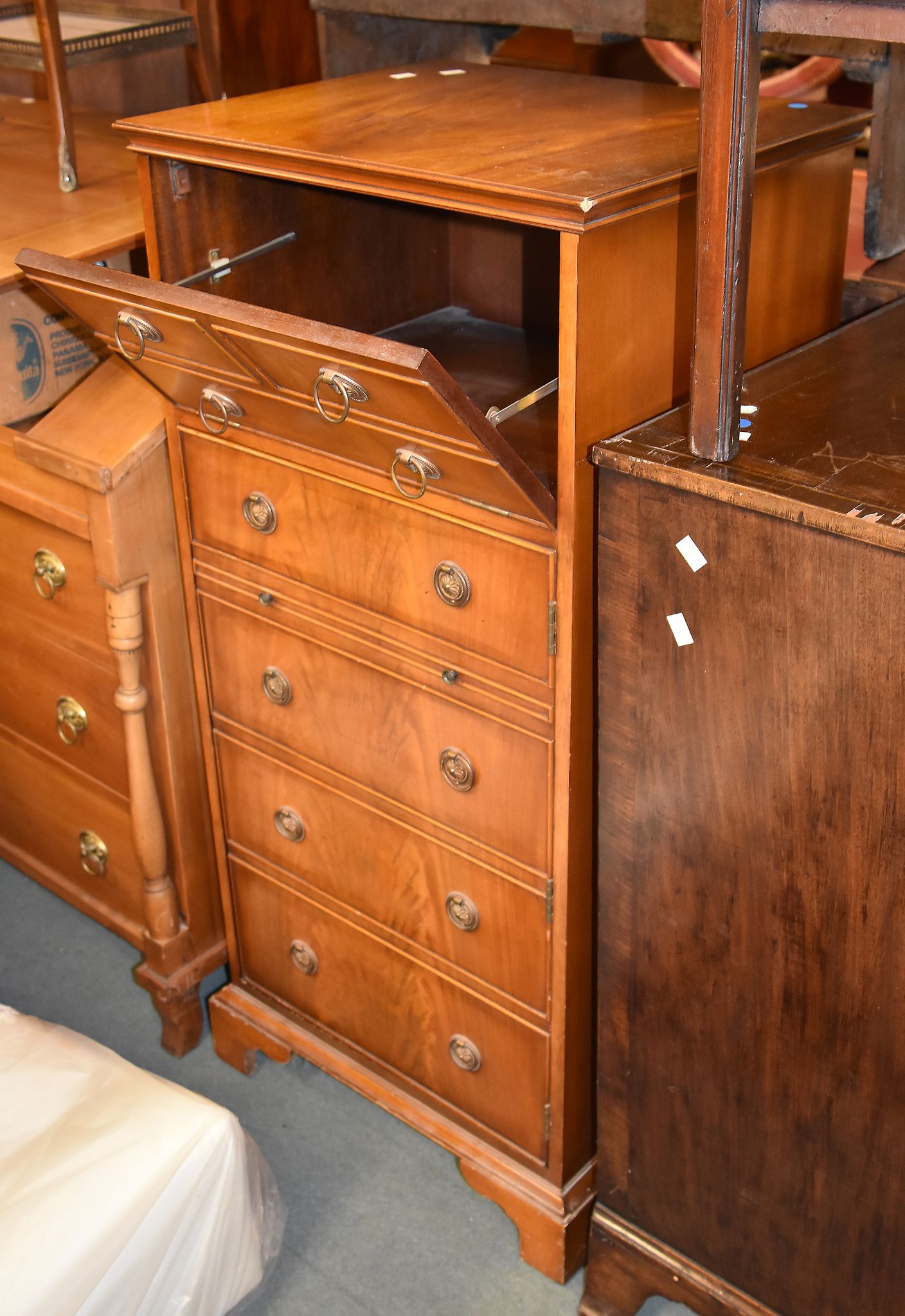 A modern flame mahogany veneered hi-fi cabinet, in the form of a chest of drawers, 123cm high