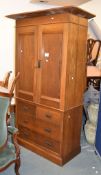 An oak press cupboard, circa 1900, with pair of cupboard doors above the drawers, 102cm wide overall