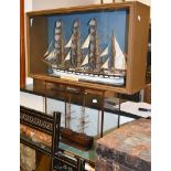 A painted wood model of a three masted ship, 20th century, square rigged, 73cm high; a cased model