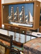 A painted wood model of a three masted ship, 20th century, square rigged, 73cm high; a cased model