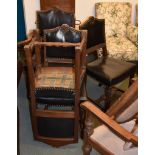 A set of six oak and leather upholstered chairs in Cromwellian style , 20th century, to include a