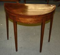 A George III mahogany folding card table, of demi-lune outline, 86cm wide