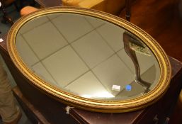 A gilt oval wall mirror, in George III style, 20th century, 82cm x 52cm