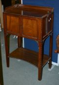 A mahogany side cabinet in George III style, 20th century, the doors enclosing two slides for a