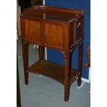 A mahogany side cabinet in George III style, 20th century, the doors enclosing two slides for a