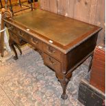 A mahogany desk in Georgian style, the rectangular top with leather inset, 75cm high, 122cm wide,