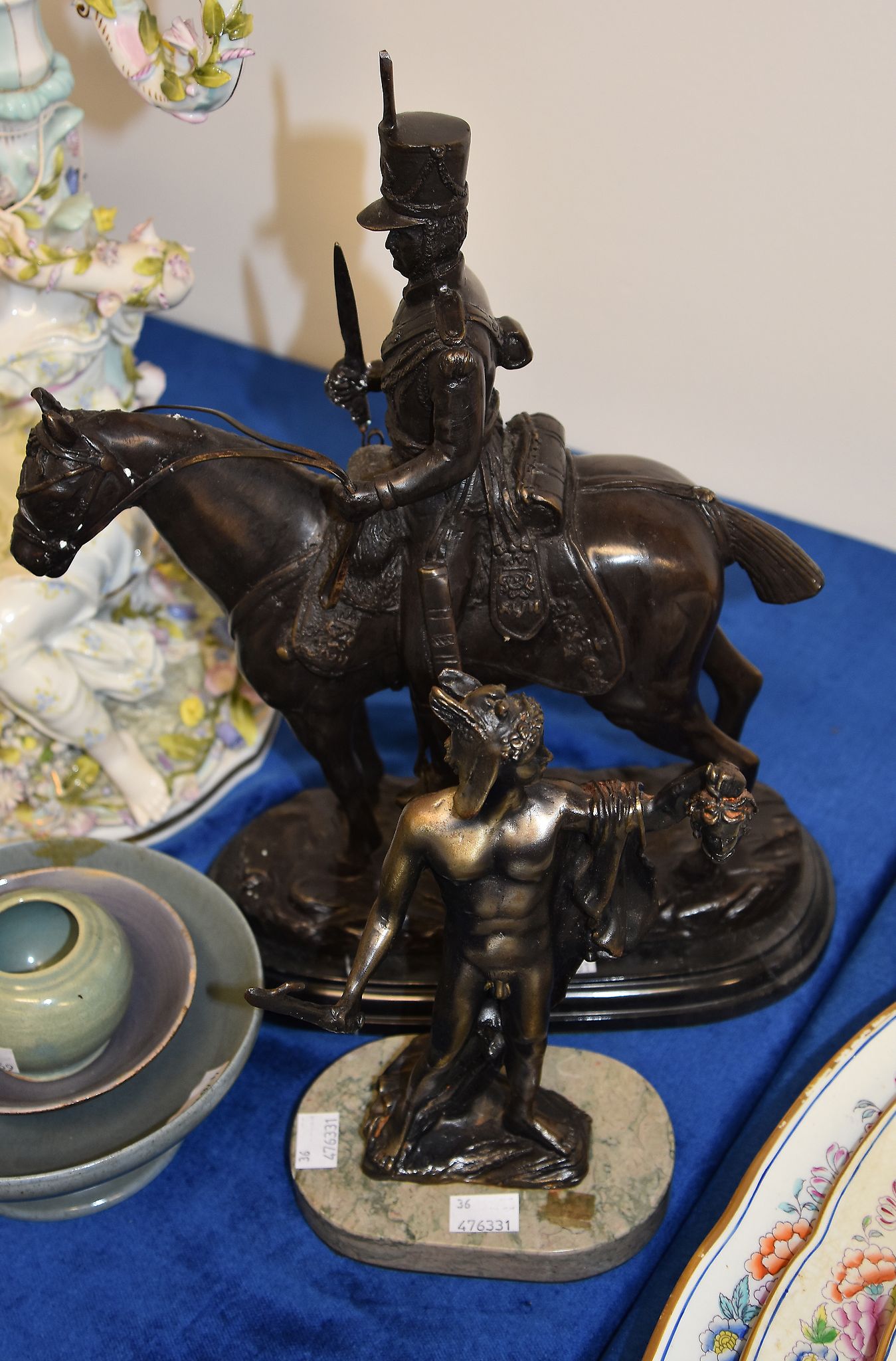 A modern bronze equestrian group, portraying an early 19th century cavalryman, on a marble base,