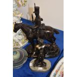 A modern bronze equestrian group, portraying an early 19th century cavalryman, on a marble base,