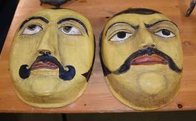 A pair of eastern papier mache masks, an Egyptian carved wood masks, two Chinese masks, and a carved