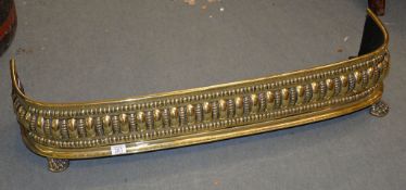 A brass fender, mid-19th century, with lobed and beaded bands, 22cm high, 106cm wide