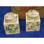 A pair of Japanese earthenware square jars, covers and inner lids, circa 1900-1920, painted in