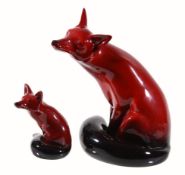 A Royal Doulton Flambe model of a fox, printed mark, signed Noke, 24cm high; and another smaller,