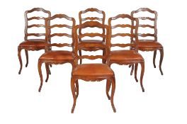 A set of six Continental walnut ladder back dining chairs with drop in seats