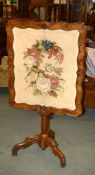 A Victorian carved walnut firescreen with needlework panel, 136cm high overall