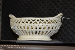 A creamware twin handled basket, probably Leeds, pierced decoration throughout, 25cm wide