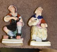 A pair of Staffordshire figures of the cobbler and his wife, of William Kent Ltd type