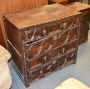 An oak chest of drawers in Charles II style, each drawer with geometric front and applied bead